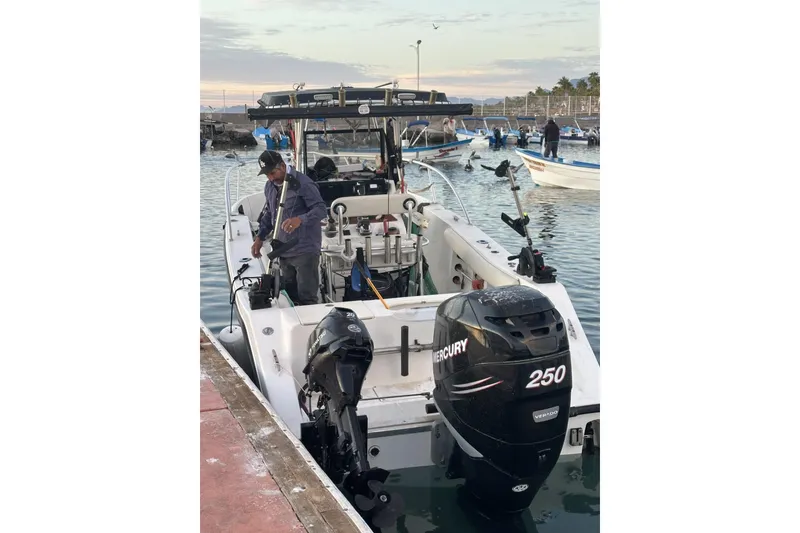 Slide: The Image of 2006 Mako 252 Center Console boat docked with Mercury 250 engine. - 11