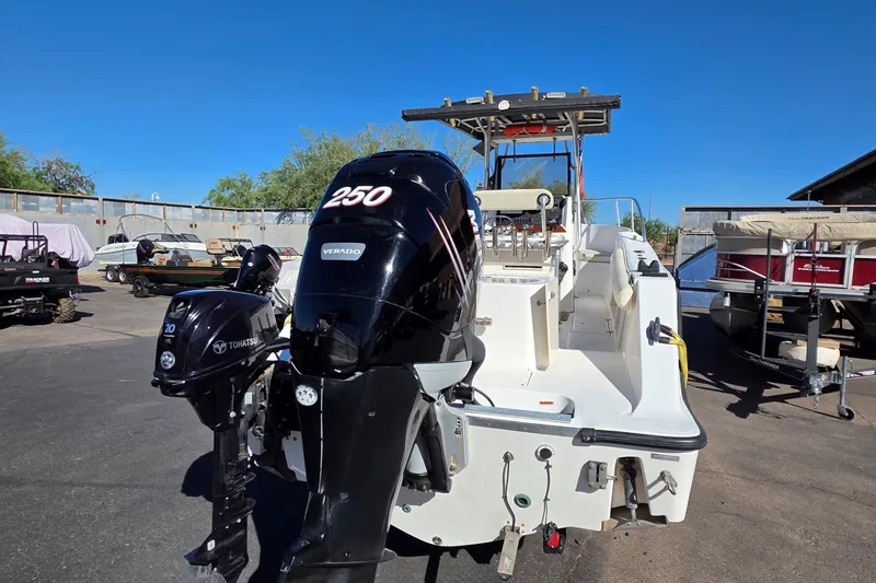 Slide: The Image of 2006 Mako 252 Center Console boat with dual outboard motors in a sunny outdoor setting. - 2