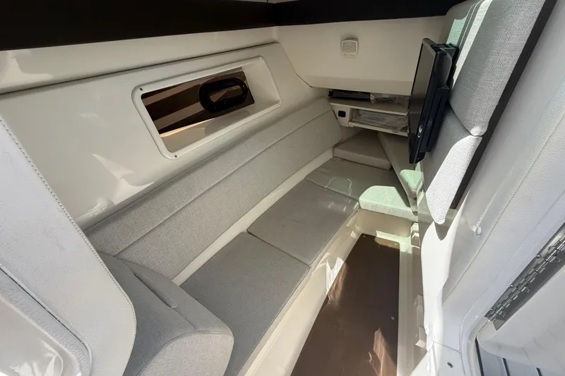 Slide: The Image of Interior cabin of 2020 Sea Ray SLX 350 Outboard with gray seating and window. - 13