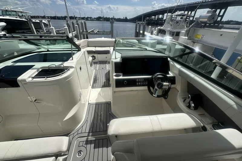 Slide: The Image of 2020 Sea Ray SLX 350 Outboard boat interior with helm and seating area. - 9