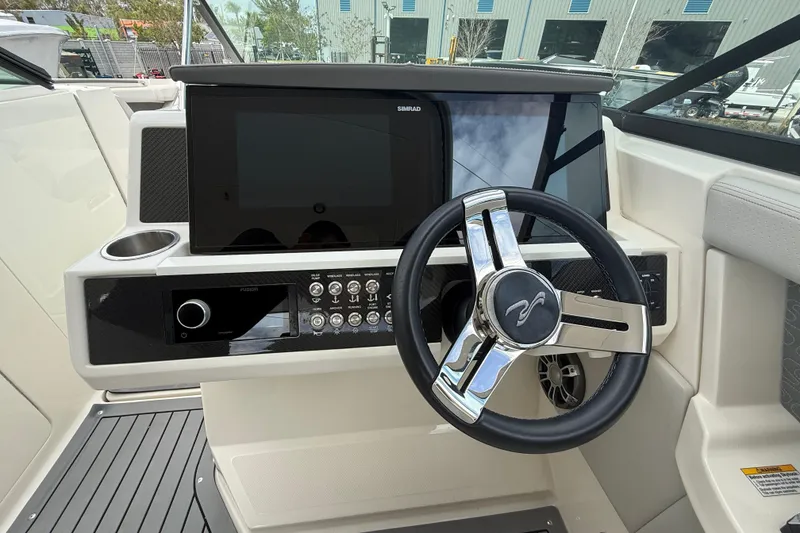 Slide: The Image of 2020 Sea Ray SLX 350 Outboard helm with modern controls and steering wheel. - 10