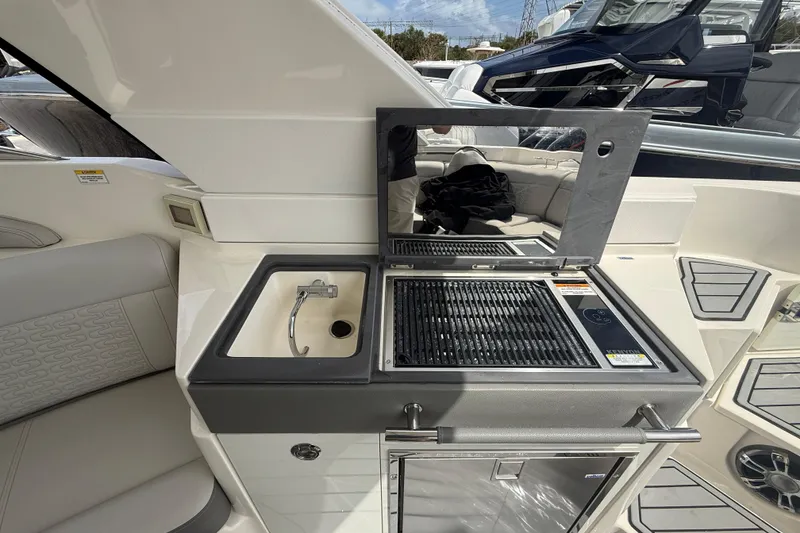 Slide: The Image of 2020 Sea Ray SLX 350 Outboard boat interior with sink and grill station. - 8