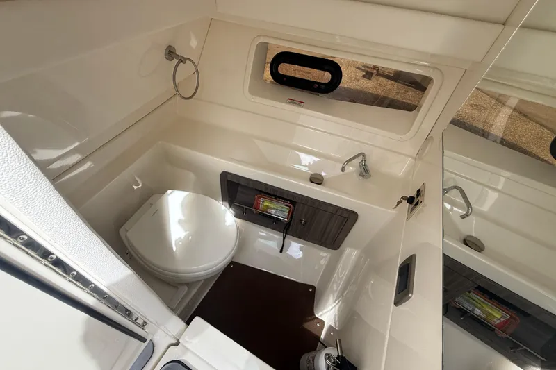 Slide: The Image of 2020 Sea Ray SLX 350 Outboard bathroom with toilet, sink, and window. - 12