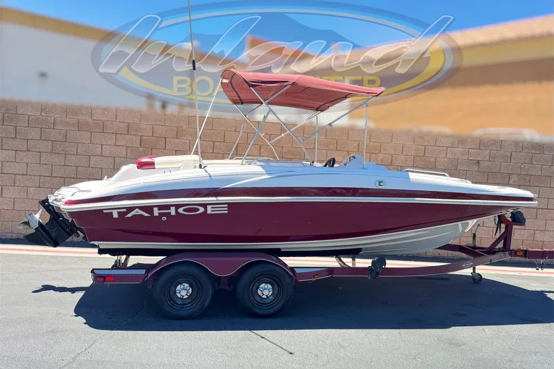 The Image of Red and white 2010 Tahoe 195 boat on trailer, parked outdoors. - 0