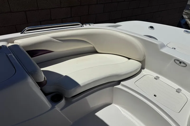 Slide: The Image of Interior seating of a 2010 Tahoe 195 boat, featuring white cushioned seats. - 11