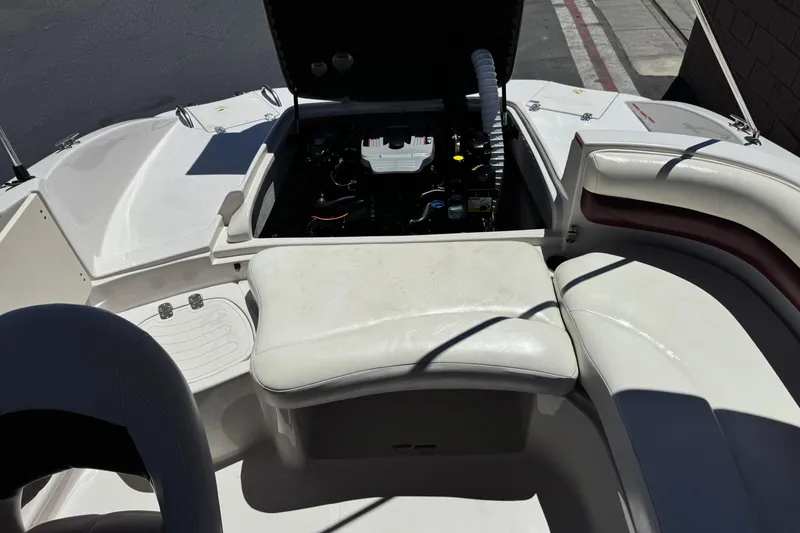 Slide: The Image of 2010 Tahoe 195 boat interior with open engine compartment and white seating. - 17