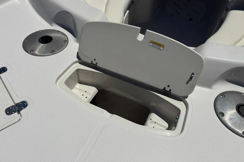 Slide: The Image of Open storage compartment on a 2010 Tahoe 195 boat deck. - 9