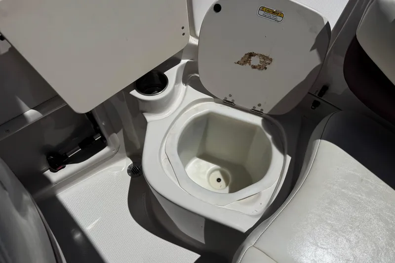 Slide: The Image of Interior of a 2010 Tahoe 195 boat featuring a built-in cooler compartment. - 20