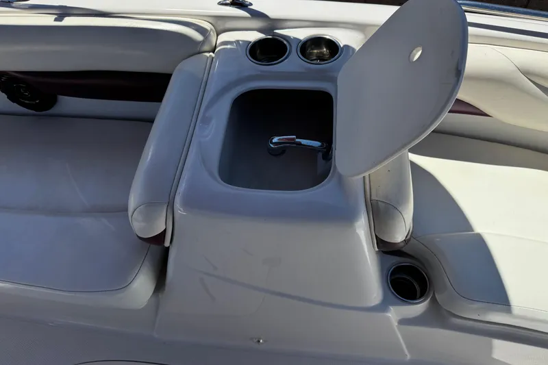 Slide: The Image of Interior of a 2010 Tahoe 195 boat featuring cup holders and storage compartment. - 15