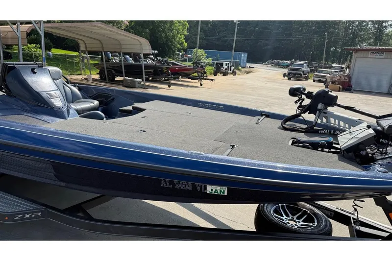 Slide: The Image of 2022 Skeeter ZXR20 SE bass boat with trolling motor, parked outdoors. - 18