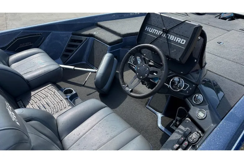 Slide: The Image of 2022 Skeeter ZXR20 SE boat interior with steering wheel and Humminbird electronics. - 19