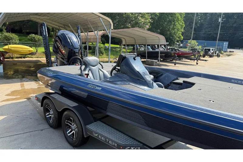 Slide: The Image of 2022 Skeeter ZXR20 SE boat on trailer, parked outdoors under canopy. - 17