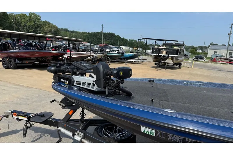 Slide: The Image of 2022 Skeeter ZXR20 SE boat on trailer in marina, surrounded by other boats. - 20