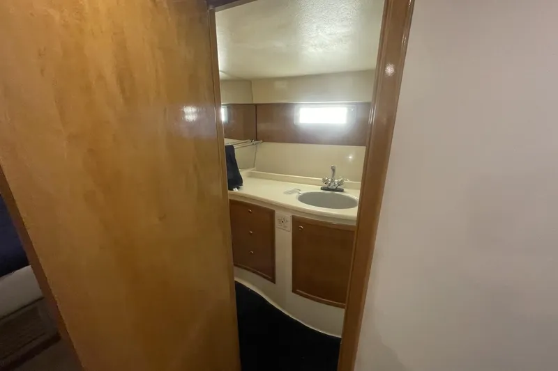 Slide: The Image of 1990 Cary 50 yacht bathroom with wooden door, sink, and modern fixtures. - 33
