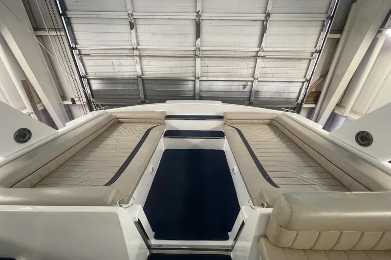 Slide: The Image of Interior of a 1990 Cary 50 boat with beige seating and blue accents. - 10