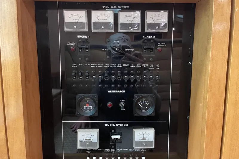 Slide: The Image of Electrical control panel of a 1990 Cary 50 boat, featuring various switches and gauges. - 39