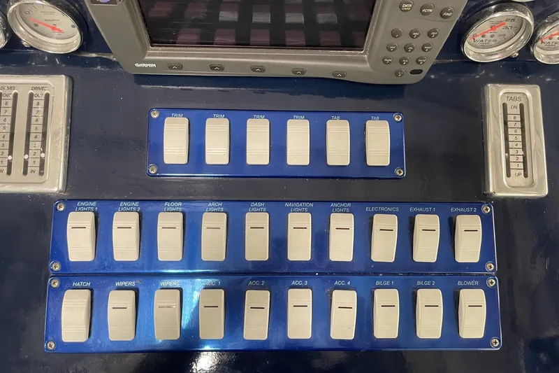 Slide: The Image of Control panel of a 1990 Cary 50 boat with switches and gauges. - 25