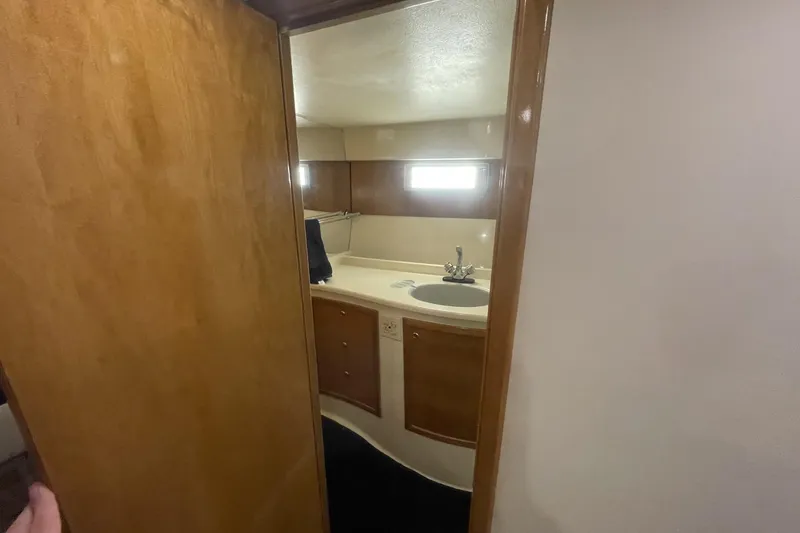 Slide: The Image of Interior of 1990 Cary 50 boat bathroom with wooden cabinetry and sink. - 32