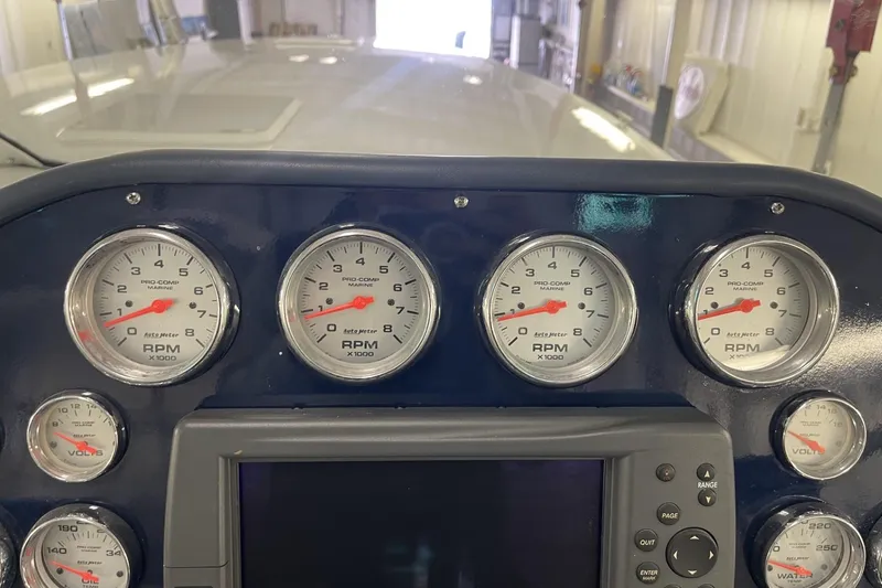 Slide: The Image of Dashboard of a 1990 Cary 50 boat with RPM and voltage gauges. - 23