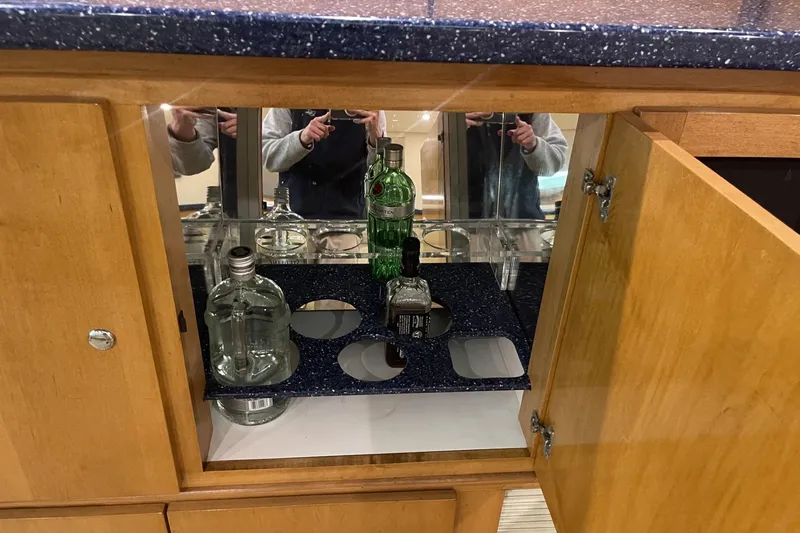 Slide: The Image of Open wooden cabinet with liquor bottles on a Cary 50, 1990 model. - 40