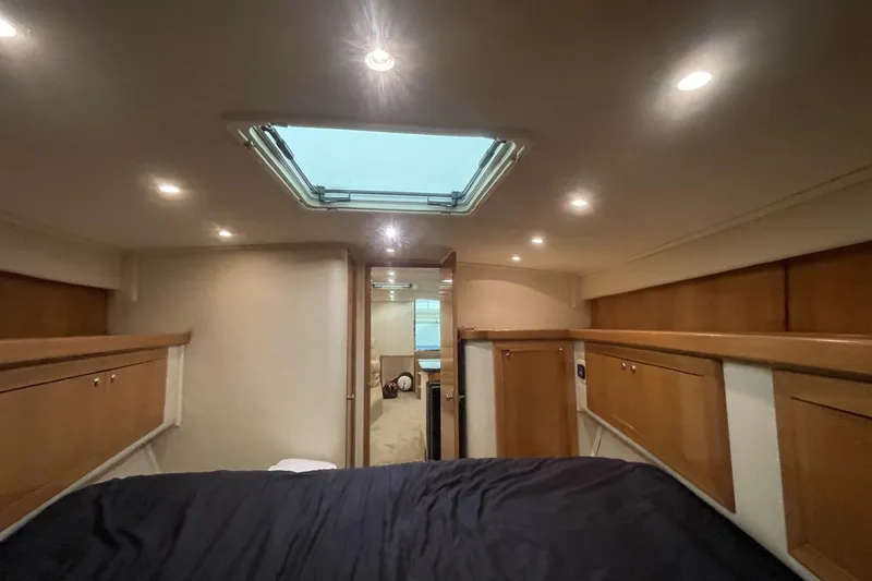 Slide: The Image of Interior cabin of a 1990 Cary 50 yacht with wood paneling and skylight. - 38