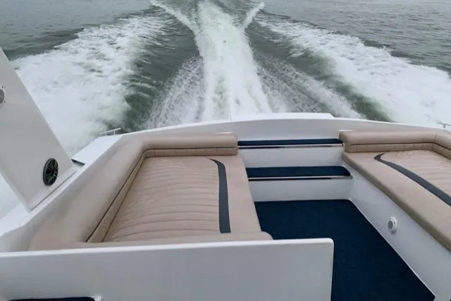 Slide: The Image of Sleek 1990 Cary 50 boat cruising, showcasing luxurious seating and powerful wake. - 42