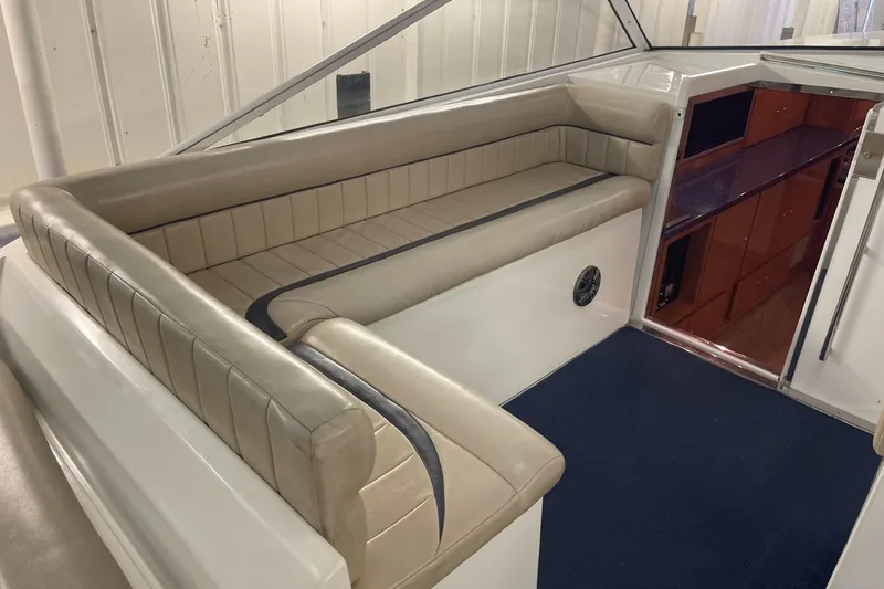 Slide: The Image of 1990 Cary 50 boat interior with beige seating and blue carpet. - 18
