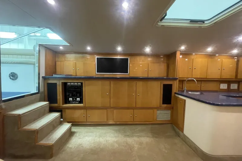 Slide: The Image of Luxurious interior of a 1990 Cary 50 yacht with wood cabinetry and modern amenities. - 29