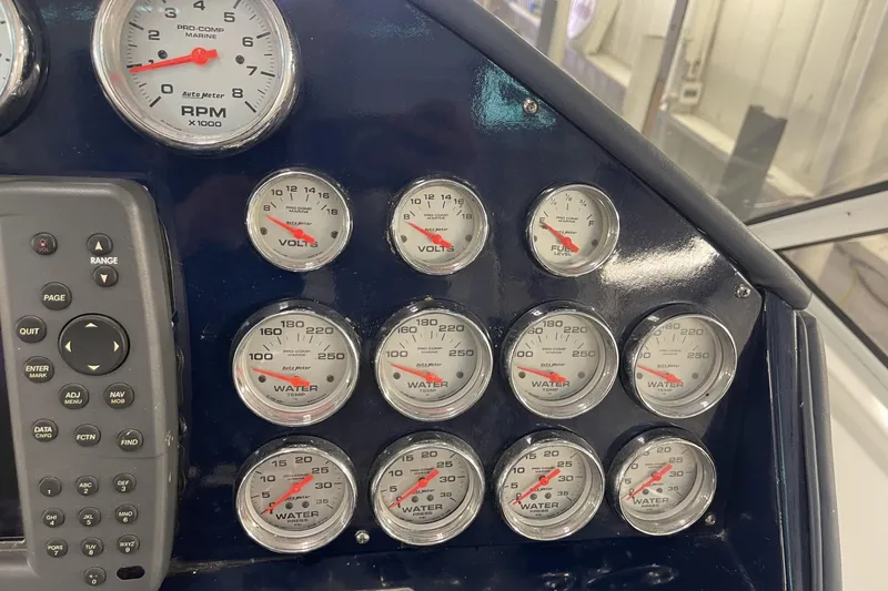 Slide: The Image of Dashboard of a 1990 Cary 50 boat with various gauges and controls. - 24