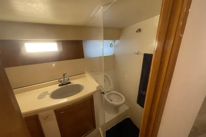 Slide: The Image of Compact bathroom in a 1990 Cary 50 boat with sink, toilet, and window. - 34