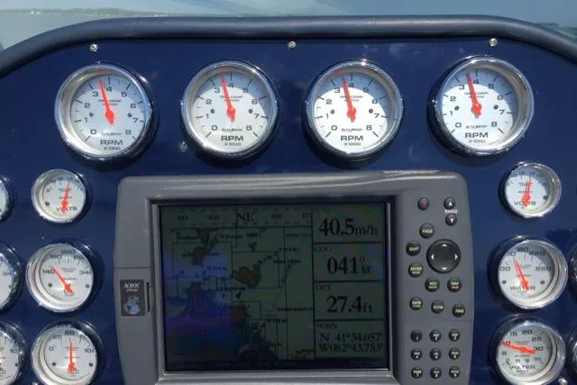 Slide: The Image of Dashboard of a 1990 Cary 50 boat with gauges and navigation display. - 44