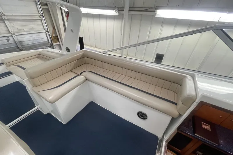 Slide: The Image of Interior of a 1990 Cary 50 boat with beige seating and blue carpet. - 16