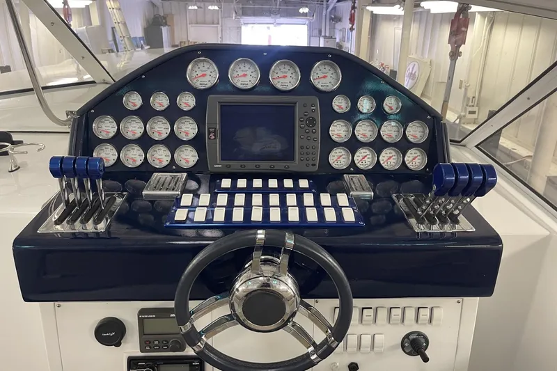 Slide: The Image of Control panel of a 1990 Cary 50 boat with gauges and steering wheel. - 20