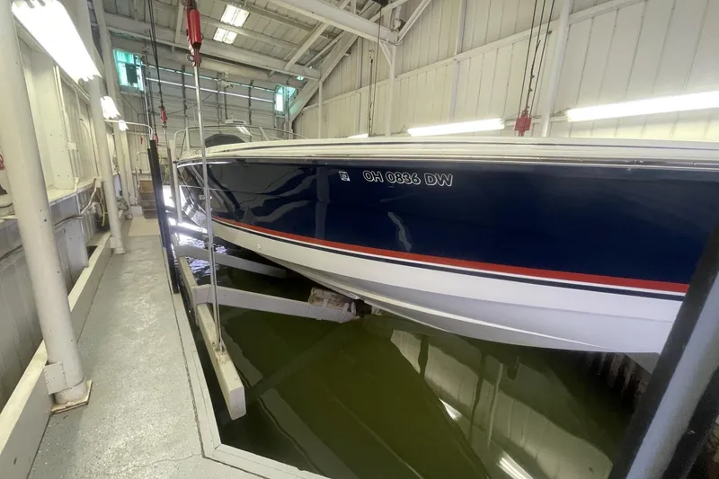 Slide: The Image of 1990 Cary 50 boat in indoor storage, elevated above water. - 4