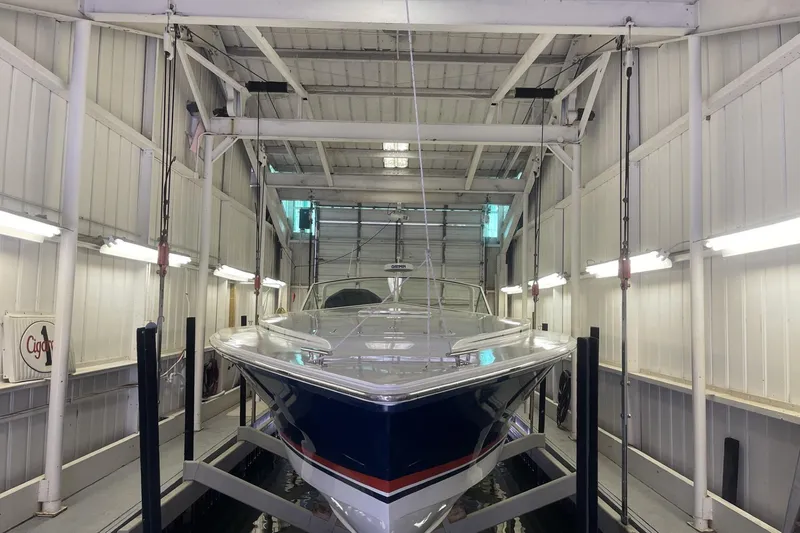 Slide: The Image of 1990 Cary 50 boat in a well-lit indoor storage facility. - 3