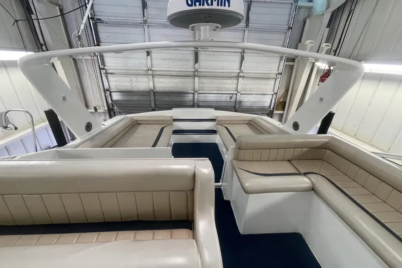 Slide: The Image of Interior of a 1990 Cary 50 boat with beige seating and Garmin equipment. - 17