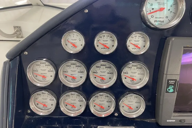 Slide: The Image of Dashboard of a 1990 Cary 50 boat with multiple gauges and a Garmin GPS device. - 22