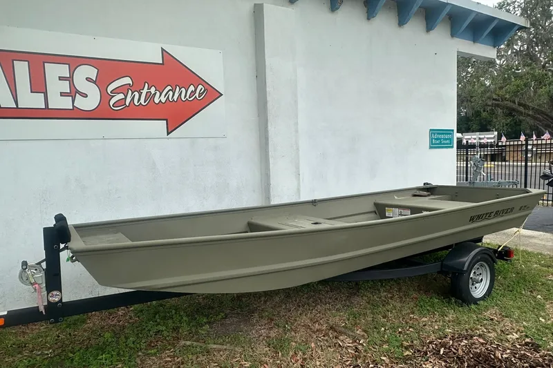 Slide: The Image of 2025 White River TOPPER 1542 Jon Boat on trailer near sales entrance. - 2