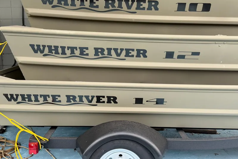 Slide: The Image of Stacked White River Jon Boats, models 10, 12, and 14, on a trailer. - 3