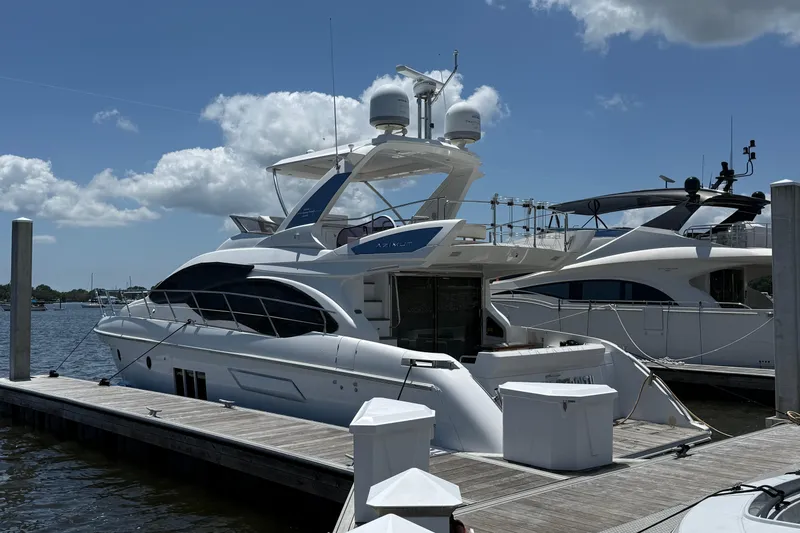 Slide: The Image of Luxury 2014 Azimut 54 yacht docked at marina under blue sky. - 3