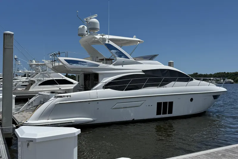 The Image of Luxury 2014 Azimut 54 yacht docked at marina under clear blue sky. - 1