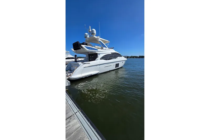 Slide: The Image of Luxury 2014 Azimut 54 yacht docked on a sunny day, showcasing sleek design and elegance. - 12