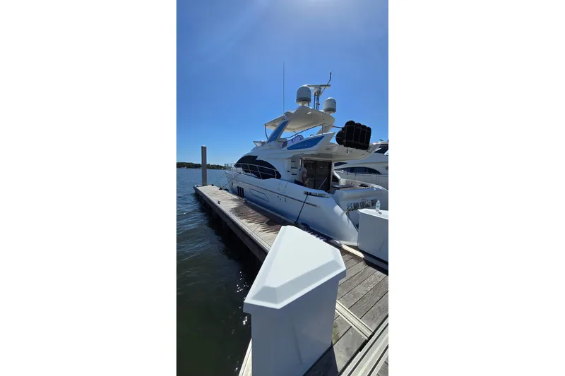 Slide: The Image of Luxury 2014 Azimut 54 yacht docked at marina under clear blue sky. - 4