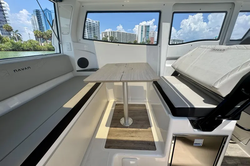 Slide: The Image of Interior of 2026 Navan C30 boat with seating and table, cityscape view. - 24