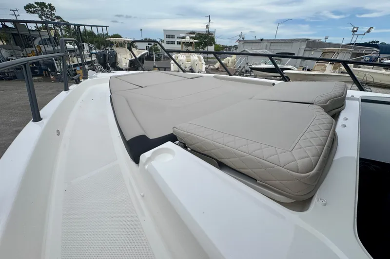 Slide: The Image of 2026 Navan C30 boat with cushioned sun deck, docked in a marina. - 50