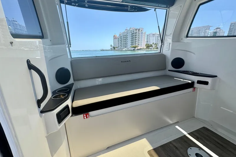 Slide: The Image of Interior of 2026 Navan C30 boat with seating, cup holders, and waterfront view. - 19