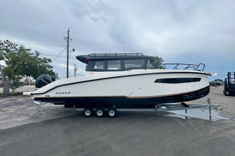 Slide: The Image of 2026 Navan C30 boat on trailer, sleek design, parked outdoors. - 3