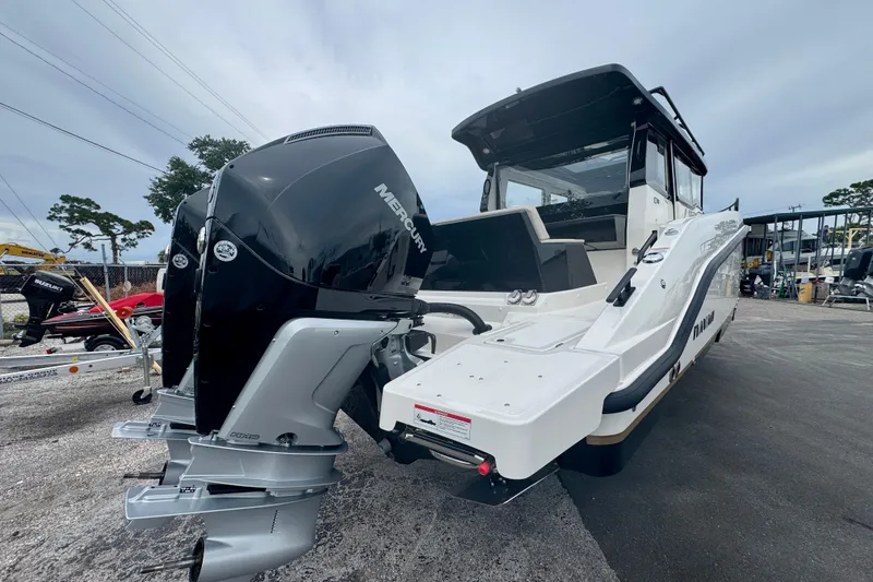 Slide: The Image of 2026 Navan C30 boat with Mercury outboard engine, parked on a lot. - 4