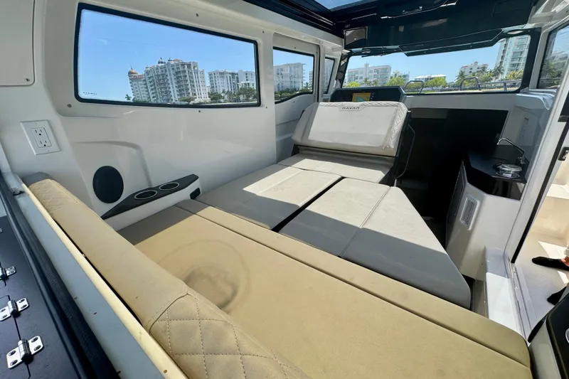 Slide: The Image of Interior of 2026 Navan C30 boat with beige seating and cityscape view through windows. - 28