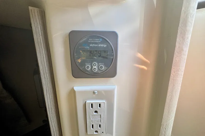 Slide: The Image of Battery monitor and electrical outlet in a 2026 Navan C30 vehicle interior. - 53